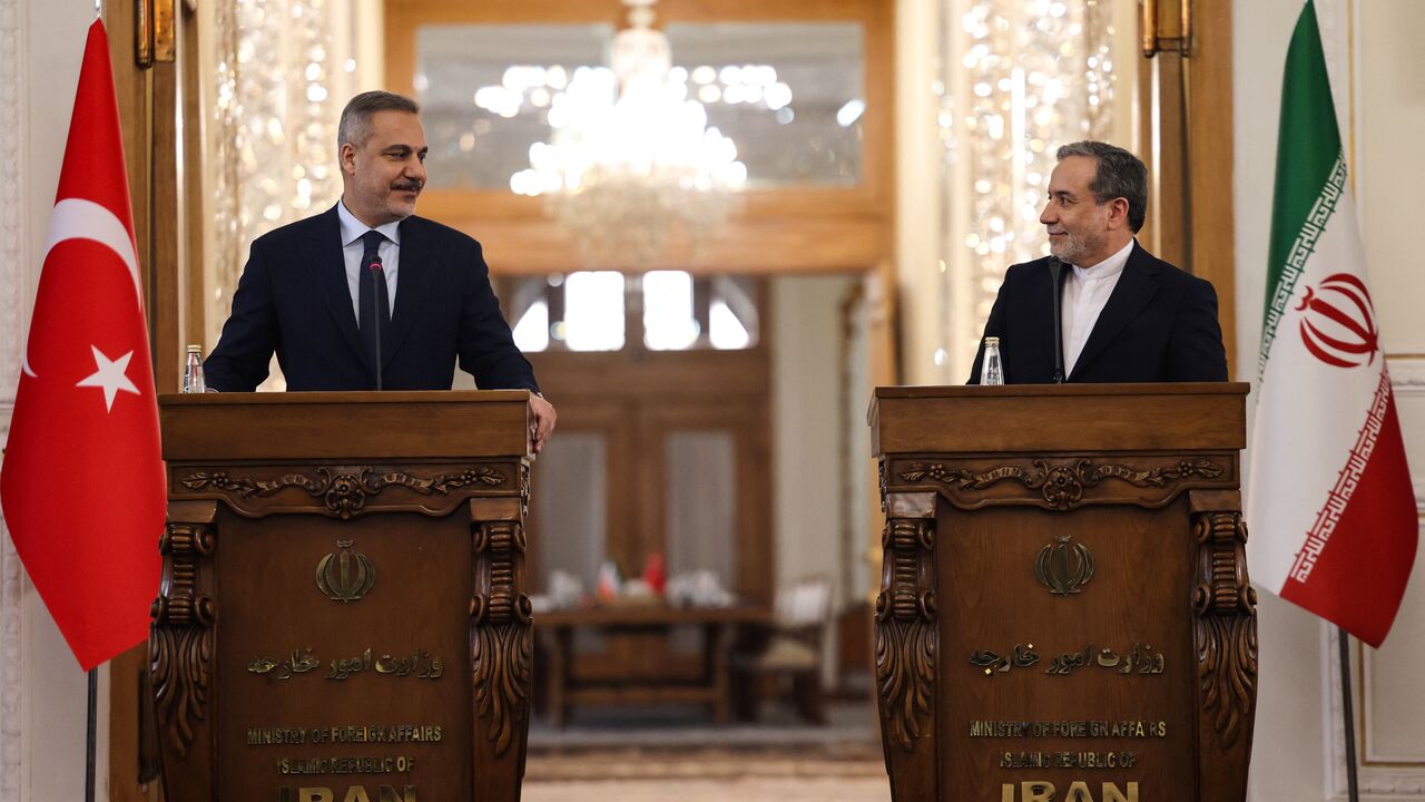 Turkey's Foreign Minister Hakan Fidan (L) and Iran's Foreign Minister Abbas Araghchi holds a press conference in Tehran on November 30, 2025. 