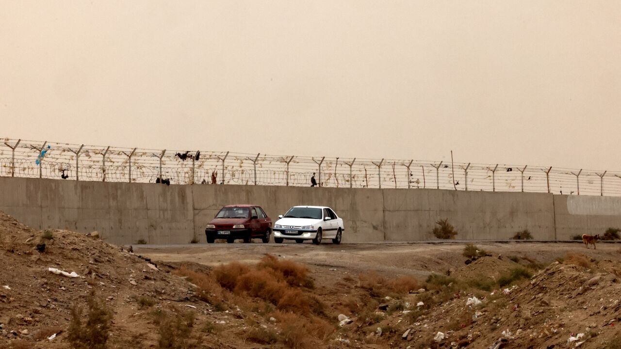 This picture shows the border wall between Iran and Afghanistan at the Milak border crossing near the town of Zabol, in the southeastern province of Sistan and Baluchistan bordering Afghanistan, on Dec. 17, 2025. 