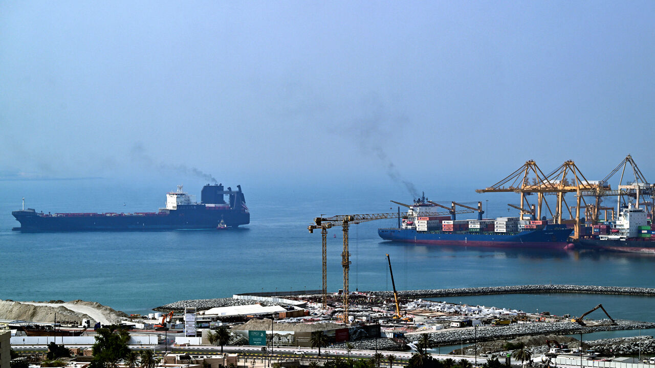 Ships are docked along a pier at the Khor Fakkan Container Terminal, the only natural deep-sea port in the region and one of the major container ports in Sharjah Emirate, along the Gulf of Oman on July 14, 2026.