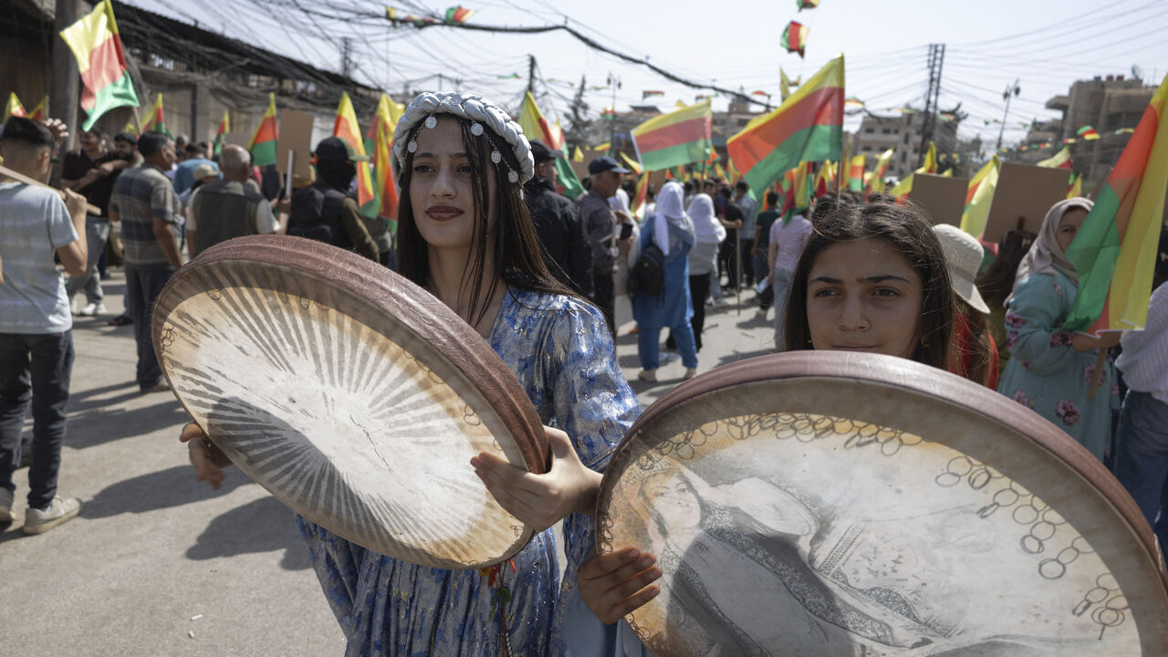 Youths play the daf, an Iranian frame drum, during a protest demanding the right to education in the Kurdish language in Al-Qamishli, Syria, on September 22, 2026. The demonstrations follow a decision by the Syrian Interim Government to allocate only Kurdish language classes in schools. (Photo by Amjad Kurdo / Middle East Images / AFP via Getty Images)