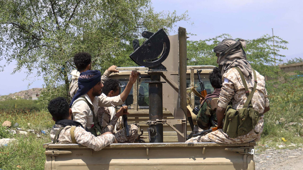 Saudi-backed Yemeni government forces ride in the back of a military truck at the Jabal Han front west of the city of Taiz following fierce battles earlier in the day as Yemen's Houthis reportedly attempted to seize control of the main route between the inland city of Taiz and the coastal city of Aden, on Oct. 3, 2026.  