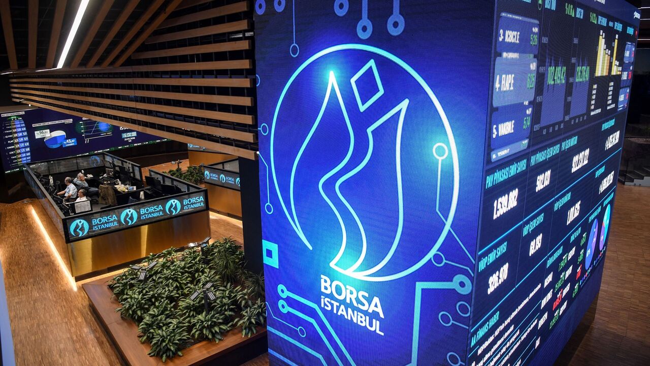 Traders work at their desks on the floor of the Borsa Istanbul