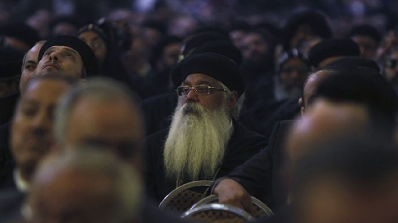 Egyptian Coptic priests react during the farewell of Pope Shenouda III, the head of Egypt's Coptic Orthodox Church during his funeral, in the Abassiya Cathedral in Cairo March 20, 2012. Thousands of mourners dressed in black gathered in Cairo on Tuesday for the funeral of Egypt's Orthodox Christian Pope Shenouda, who spent his final years trying to comfort a community disturbed by the rise of political Islam. REUTERS/Amr Abdallah Dalsh (EGYPT - Tags: OBITUARY RELIGION)