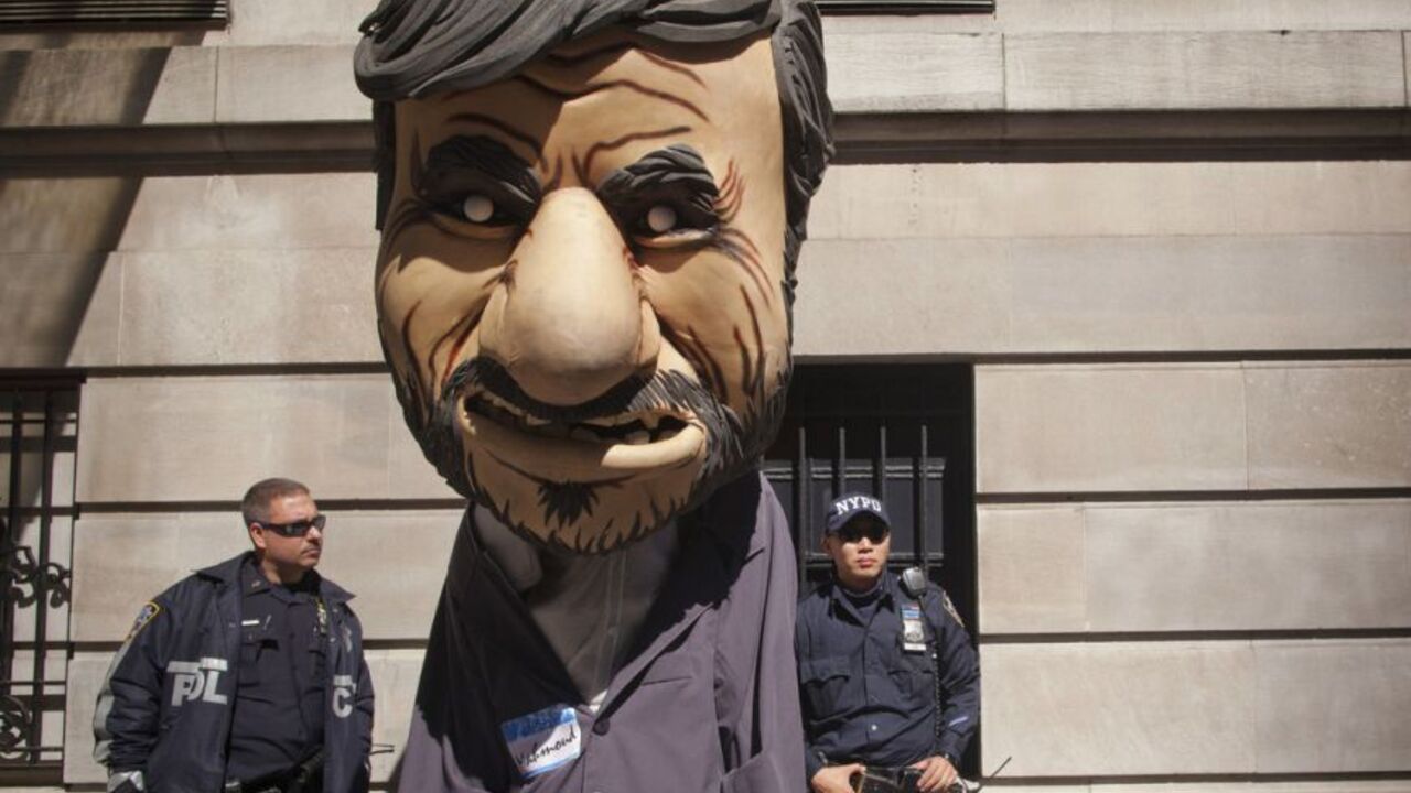 New York police officers look at a man dressed as Iranian President Mahmoud Ahmadinejad during a protest against Ahmadinejad outside the Warwick Hotel in New York September 25, 2012. Ahmadinejad is staying at the hotel during his visit to New York for the United Nations General Assembly.  REUTERS/Andrew Kelly (UNITED STATES - Tags: POLITICS CIVIL UNREST)