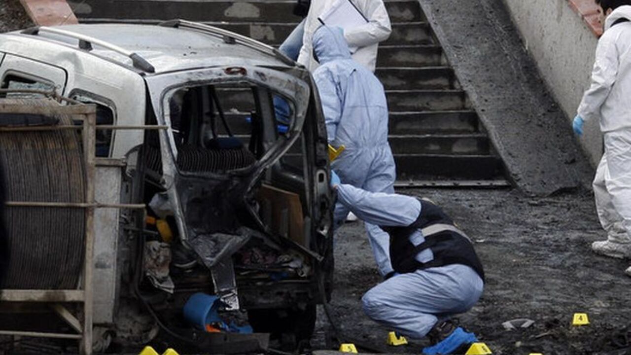 Police forensic officers inspect the scene of a bombing near police vehicles in Istanbul March 1, 2012. A remote control bomb injured 10 police officers on Thursday as their vehicle passed close to the Istanbul headquarters of Turkey's ruling AK Party, Turkish police said. Istanbul police chief Huseyin Capkin said the device was placed on a motorcycle and set off by remote control as a police vehicle drove past, near the AK Party building and the offices of a conservative business association.   REUTERS/Osm
