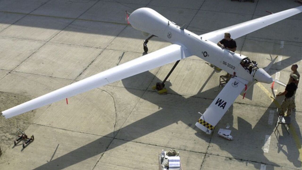 Members of the 11th Reconnaissance Squadron from Indian Springs, Nev., perform pre-flight checks on the Predator unmanned aerial vehicle prior to a mission, in this November 9, 2001 file photo shot at an undisclosed location. In the rugged mountains of western Pakistan, missiles launched by unmanned Predator or Reaper drones have become so commonplace that some U.S counterterrorism officials liken them to "cannon fire." To match Special Report USA-PAKISTAN-DRONES   REUTERS/U.S. Air Force/Handout/Files    (U