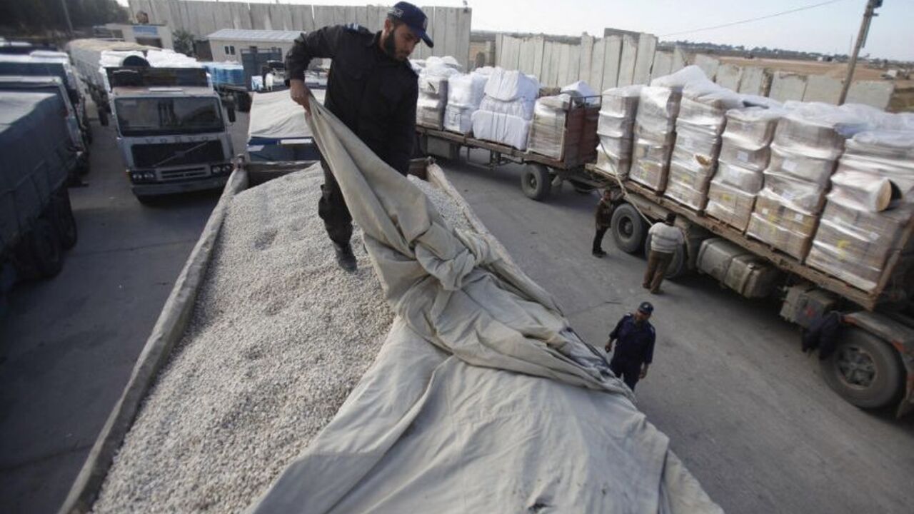 A member of Hamas security forces checks a truck loaded with gravel at the Kerem Shalom crossing between Israel and the southern Gaza Strip December 30, 2012. Israel eased its blockade of Gaza on Sunday, allowing a shipment of gravel for private construction into the Palestinian territory for the first time since Hamas seized control in 2007.  
REUTERS/Ibraheem Abu Mustafa (GAZA - Tags: POLITICS)