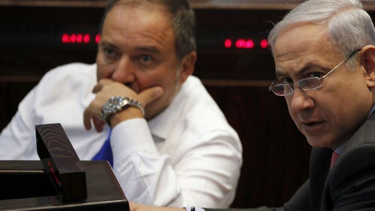 Israel's Prime Minister Benjamin Netanyahu (R) and Foreign Minister Avigdor Lieberman attend a session of the Knesset, the Israeli parliament, in Jerusalem August 3, 2011. Israel's parliament passed a law on Wednesday aimed at cutting housing prices, but protesters seeking wider economic reforms pledged to step up their campaign against rising living costs. Netanyahu has been under pressure in the past few weeks to lower living costs in what local media have dubbed an uprising of the middle class. REUTERS/B