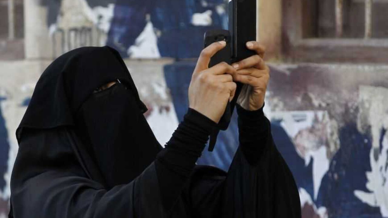 A protester uses a mobile device to take a video of an anti-government protest in the capital Manama December 17, 2012. Protesters, shouting anti-government slogans, attempted to regroup from various points to march against a ban on demonstrations. Riot police dispersed them and arrested at least three protesters. REUTERS/Hamad I Mohammed (BAHRAIN - Tags: POLITICS CIVIL UNREST)