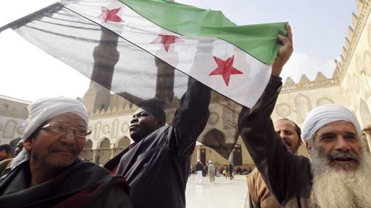 People shout slogans against Syrian President Bashar al-Assad while holding a Syrian opposition flag after Friday prayers led by Egyptian Cleric Sheikh Yusuf al-Qaradawi, chairman of the International Union of Muslim Scholars, at Al Azhar mosque in old Cairo December 28, 2012. REUTERS/Amr Abdallah Dalsh (EGYPT - Tags: POLITICS CIVIL UNREST RELIGION)