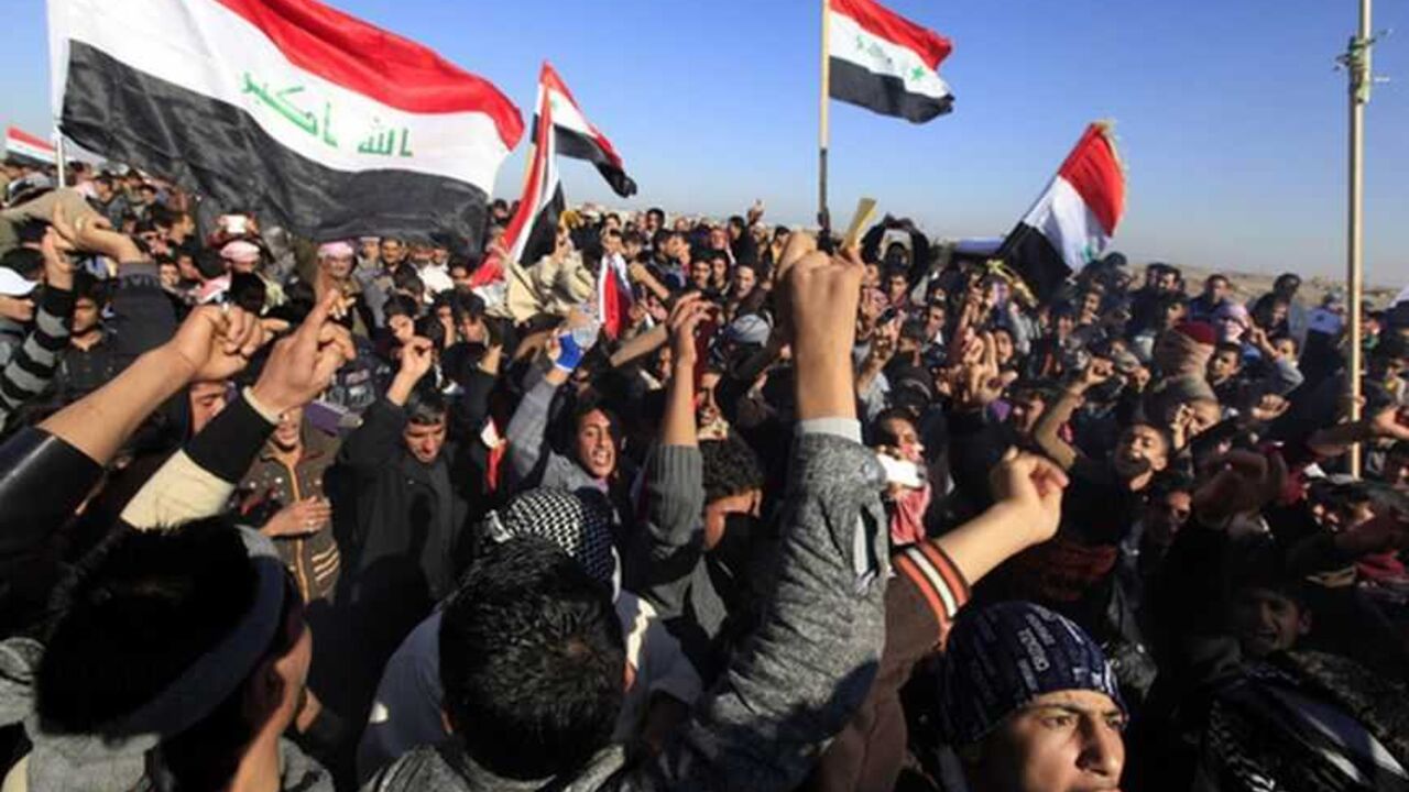 Iraqi Sunni Muslims wave Iraqi national flags during an anti-government demonstration in Falluja, 50 km (30 miles) west of Baghdad, December 28, 2012. Tens of thousands of protesters from Iraq's Sunni Muslim minority poured onto the streets after Friday prayers in a show of force against Shi'ite Prime Minister Nuri al-Maliki, keeping up a week-old blockade of a highway. Around 60,000 people blocked the main road through the city of Falluja, setting fire to the Iranian flag and shouting "out, out Iran! Baghd