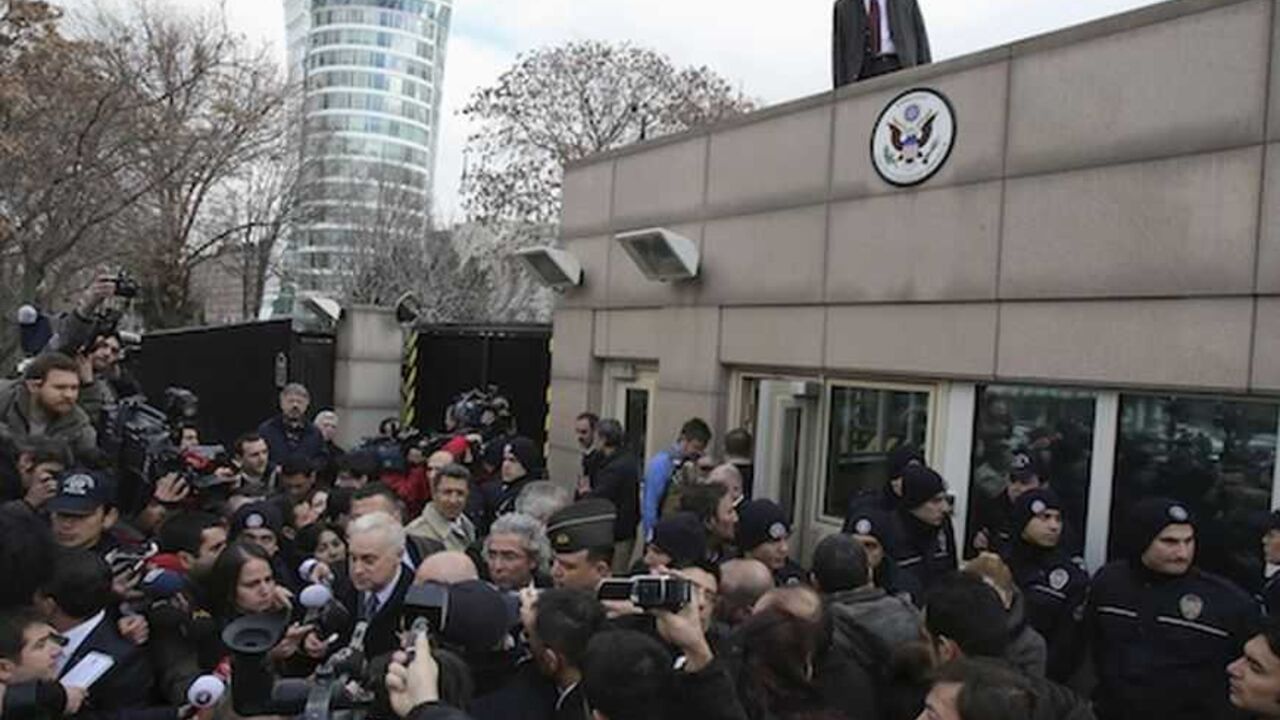 U.S. Ambassador to Turkey Francis Ricciardone (L, with white hair) speaks to media outside of the U.S. Embassy in Ankara February 1, 2013. A suicide bomber from a far-left group killed a Turkish security guard at the U.S. embassy in Ankara on Friday, blowing the door off a side entrance and sending smoke and debris flying into the street. The attacker blew himself up inside U.S. property, Ankara Governor Alaaddin Yuksel said. The blast sent masonry spewing out of the wall and could be heard a mile away. REU