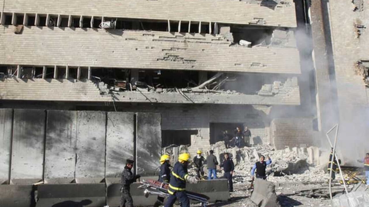 Iraqi security personnel are seen at the site of a suicide bomb attack in Kirkuk, 250 km (155 miles) north of Baghdad February 3, 2013. A suicide bomber driving a car and gunmen disguised in police uniforms killed at least 33 people in the Iraqi city Kirkuk on Sunday when they tried to storm the police headquarters. REUTERS/Ako Rasheed (IRAQ - Tags: CIVIL UNREST) - RTR3DAK7