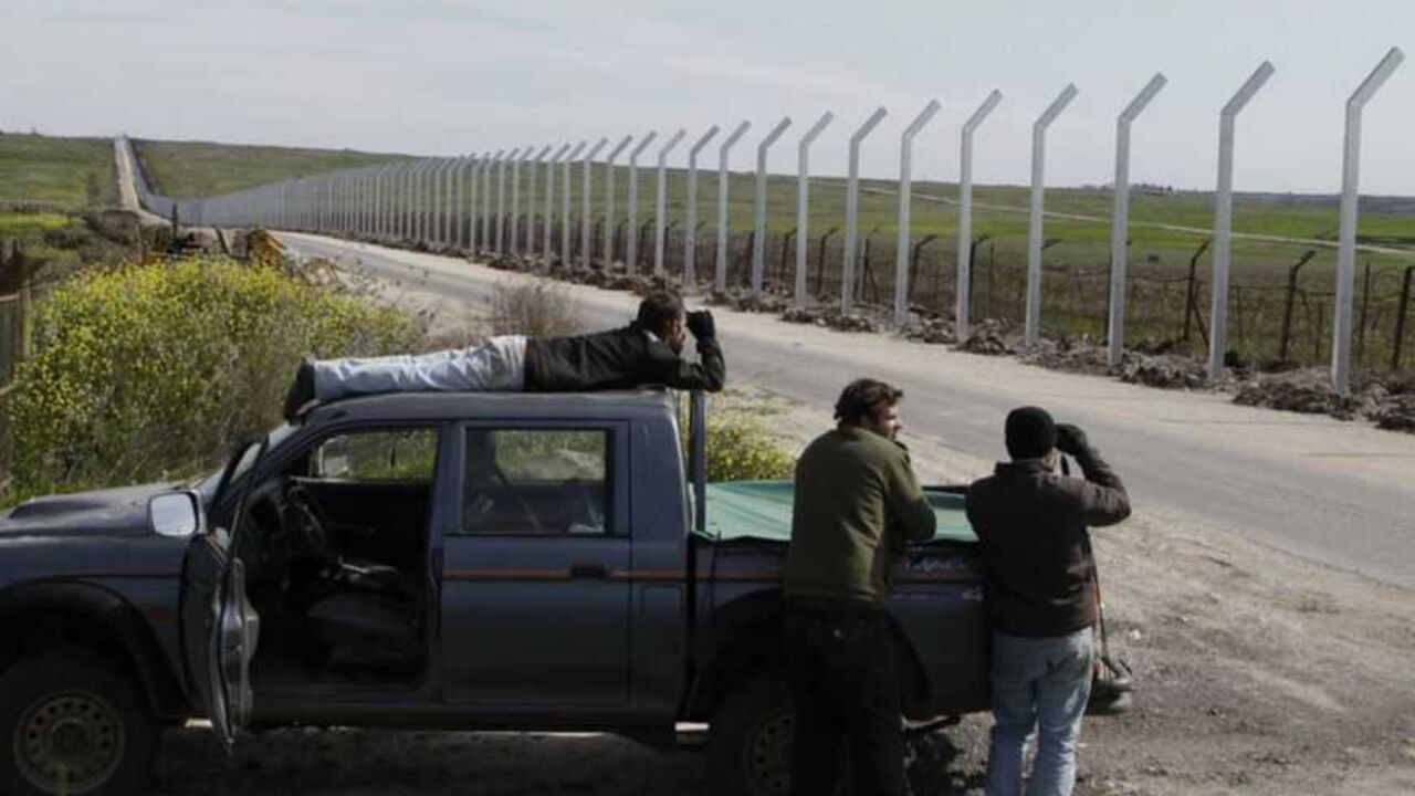 Israelis use binoculars to see the fighting in the Syrian village of al-Jamlah, from the Israeli occupied Golan Heights, close to the ceasefire line between Israel and Syria March 7, 2013. Israel voiced confidence on Thursday that the United Nations could secure the release of U.N. peacekeepers seized by Syrian rebels near the Golan Heights, signalling it would not intervene in the crisis. Israel captured the Golan Heights in the 1967 Middle East war and annexed it in 1981 in a move not recognized internati