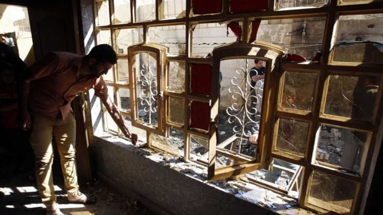 Iraqi residents examine the damage inflicted on their house by a car bomb attack in the Zaafaraniya neighbourhood in Baghdad March 19, 2013. A dozen car bombs and suicide blasts tore into Shi'ite districts in Baghdad and south of the Iraqi capital on Tuesday, killing more than 50 people on the 10th anniversary of the U.S.-led invasion that ousted Saddam Hussein.  REUTERS/Thaier al-Sudani (IRAQ - Tags: CIVIL UNREST CONFLICT) - RTR3F6Q3