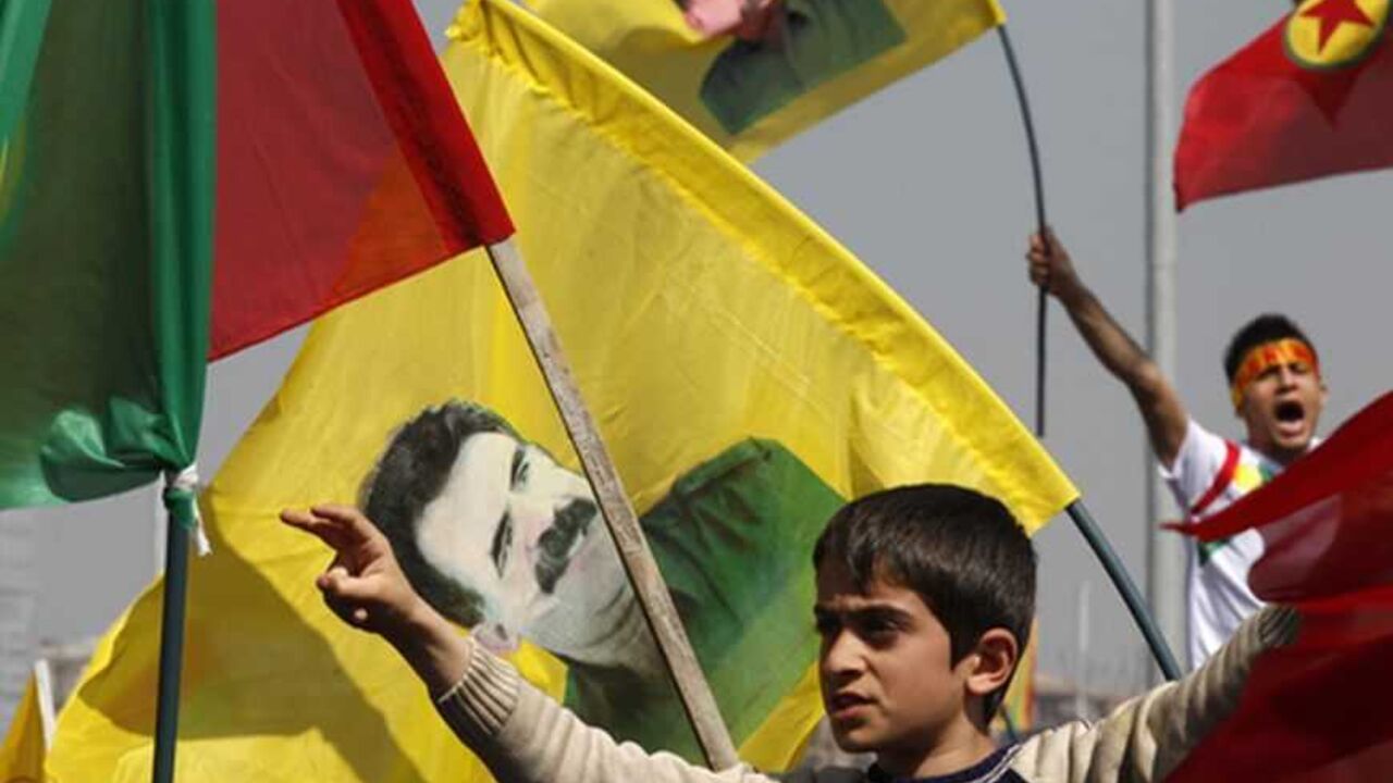Demonstrators hold Kurdish flags and flags with portraits of jailed Kurdistan Workers Party (PKK) leader Abdullah Ocalan during a gathering to celebrate Newroz in the southeastern Turkish city of Diyarbakir March 21, 2013. Ocalan ordered his fighters on Thursday to cease fire and withdraw from Turkish soil as a step to ending a conflict that has killed 40,000 people, riven the country and battered its economy. Hundreds of thousands of Kurds, gathered in the regional centre of Diyarbakir, cheered and waved b