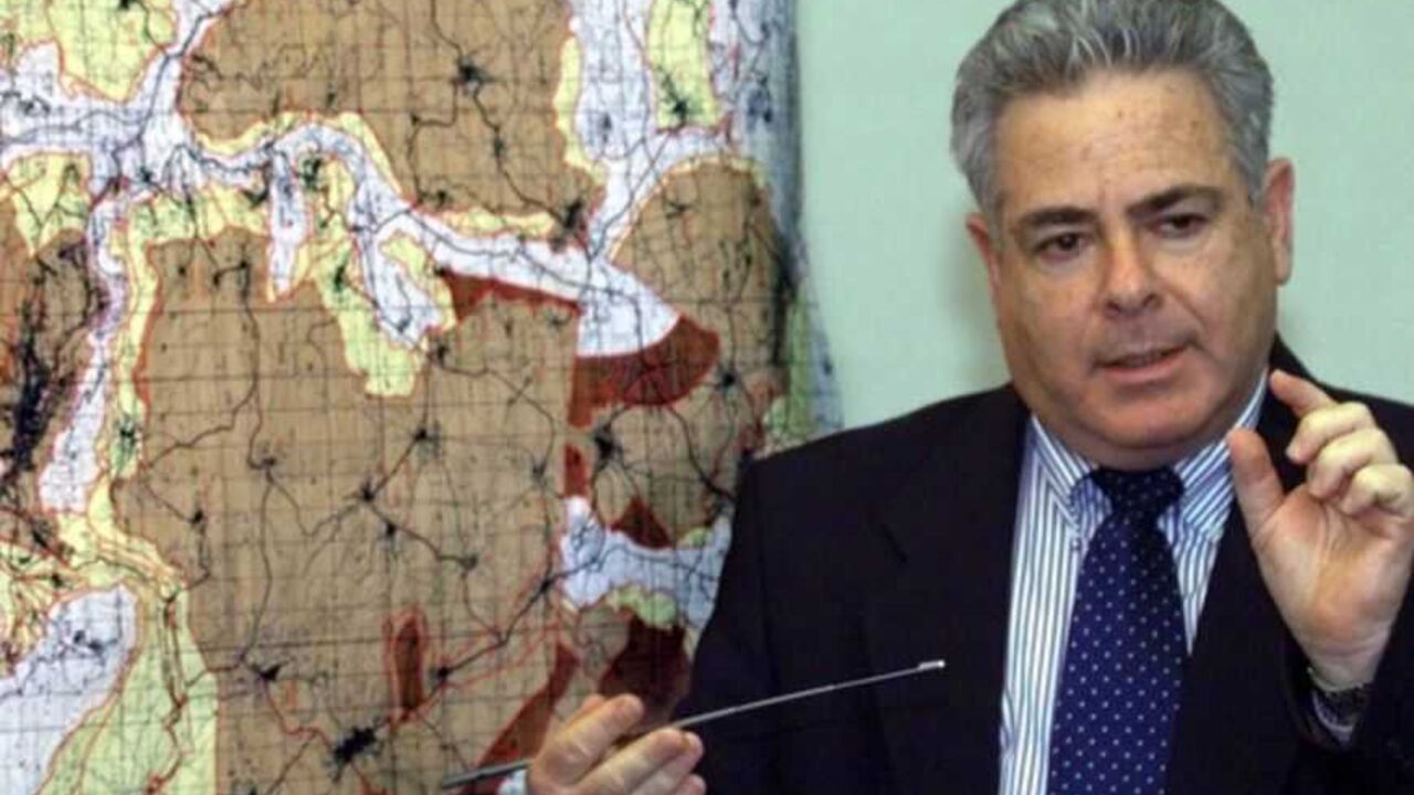 Deputy Defense Minister Ephriam Sneh in front of a large map of the West Bank during a press conference March 19 at which he announced the Israeli cabinet decision to go ahead with a further redeployment from 6.1% of West Bank land to be handed over to full Palestinian Authority. control. The dark brown areas show areas to be included in the redeployment in the northern part of the West Bank. The Palestinians will control 60% of their population but only a bit less than 20% of the West Bank land after the 6