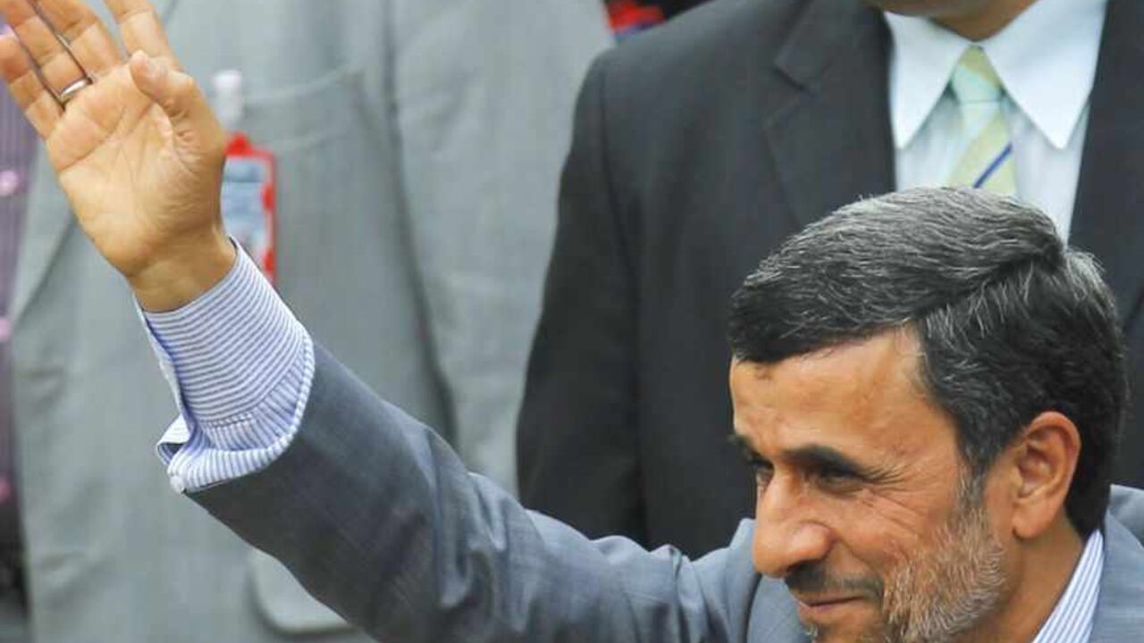 Iran's President Mahmoud Ahmadinejad waves to supporters during a ceremony to swear Venezuela's President Nicolas Maduro (not pictured) into office, in Caracas April 19, 2013. Maduro was sworn in as Venezuela's president on Friday at a ceremony attended by several countries' leaders, after a decision to widen an electronic audit of the vote took some of the heat out of a dispute over his election. REUTERS/Carlos Garcia Rawlins (VENEZUELA - Tags: POLITICS ELECTIONS) - RTXYSR0