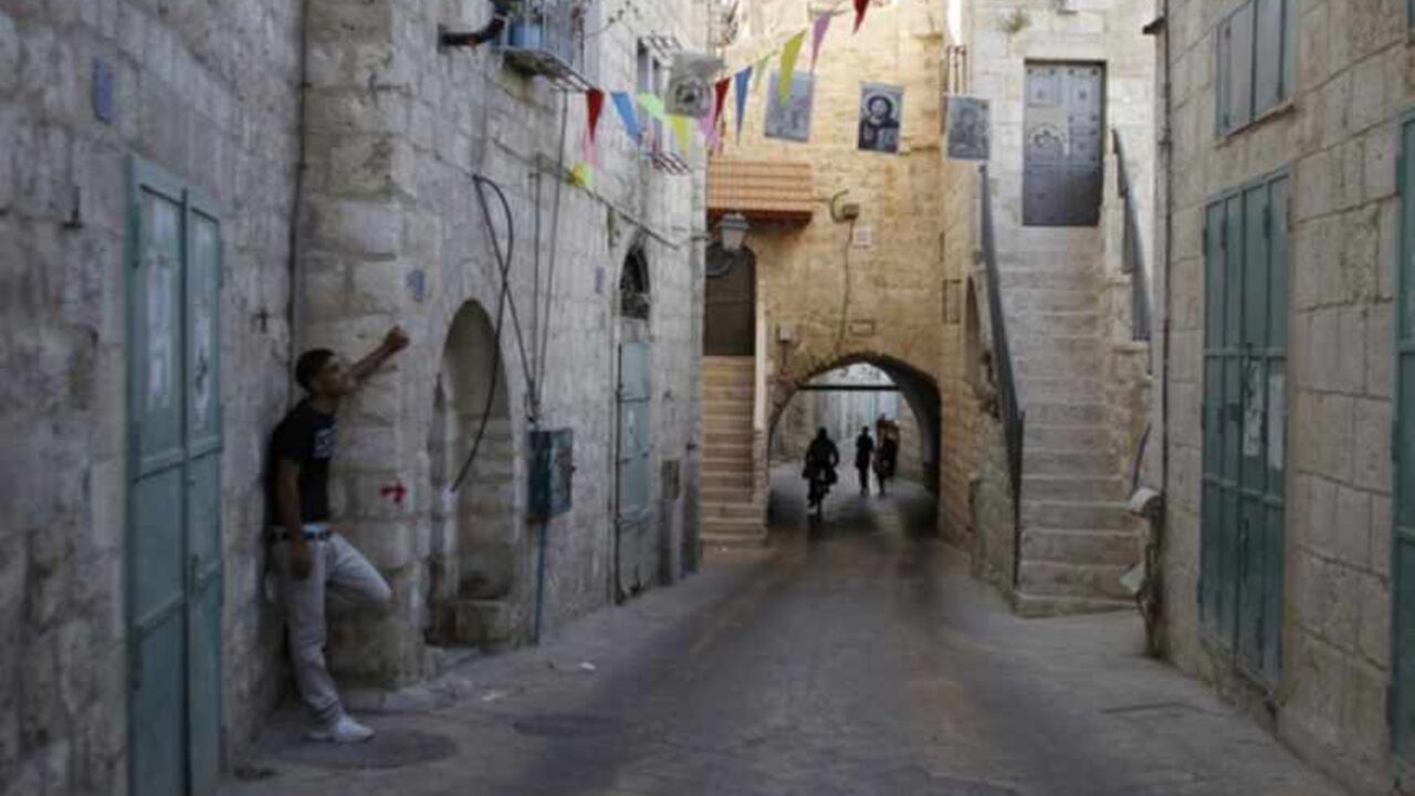 A Palestinian stands on a section of the Pilgrimage Route, the path which tradition says Joseph and Mary took into the West Bank city of Bethlehem in their trek from Nazareth some 2,000 years ago, June 28, 2012. Palestinians hope to persuade UNESCO this weekend to declare parts of Bethlehem, including the Pilgrimage Route, and its Church of the Nativity endangered World Heritage sites in order to expedite funding for repairs. REUTERS/Ammar Awad (WEST BANK - Tags: POLITICS RELIGION) - RTR34AO6
