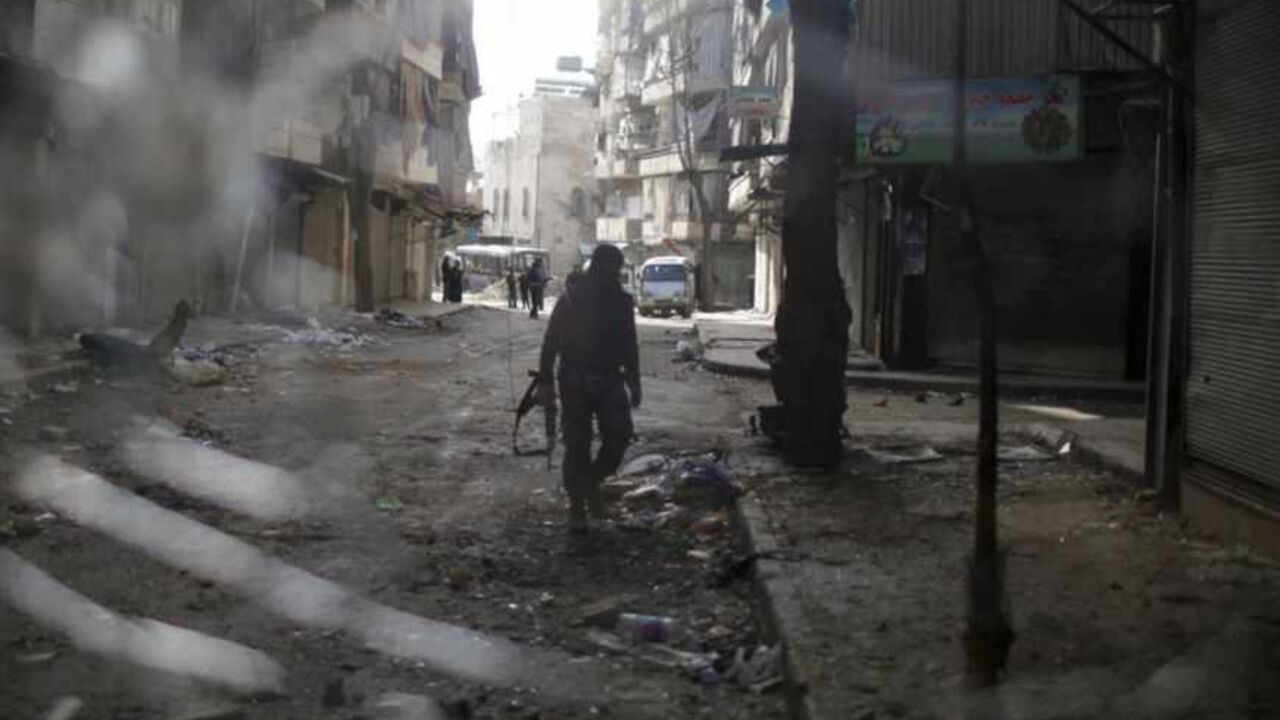 A fighter from the Islamist Syrian rebel group Jabhat al-Nusra is seen through a smashed bus window during a fight with forces loyal to President Bashar al Assad at the front line in Aleppo December 24, 2012. Syria special envoy Lakhdar Brahimi discussed solving the country's conflict with President Bashar al-Assad on Monday, but the opposition expressed deepening frustration with the mission following what it called the latest massacre of civilians. REUTERS/Ahmed Jadallah (SYRIA - Tags: CIVIL UNREST POLITI