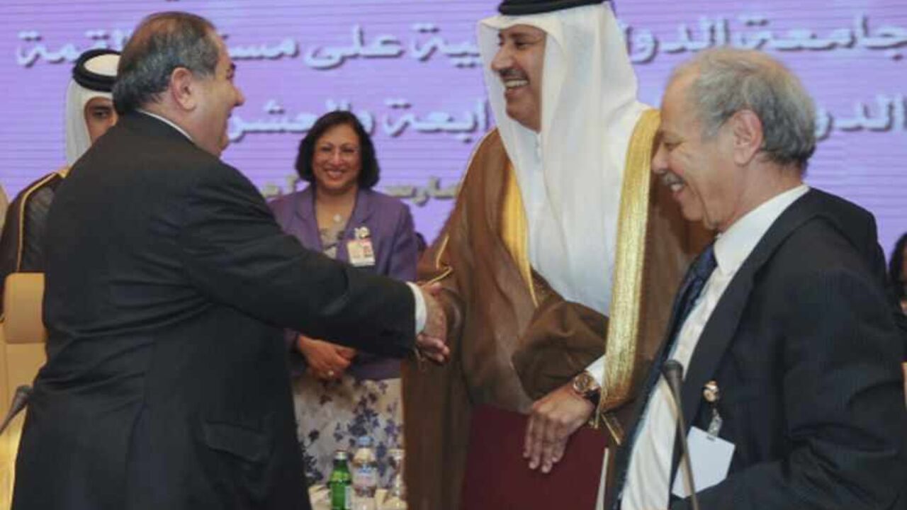 Iraq's Foreign Minister Hoshiyar Zebari (L) shakes hands with Qatari Foreign Minister Sheikh Hamed bin Jassem Jaber al-Thani (C) during preparatory meeting with Arab foreign ministers ahead of the annual Arab League Summit in Doha March 24, 2013. REUTERS/Stringer (QATAR - Tags: POLITICS) - RTXXVRM