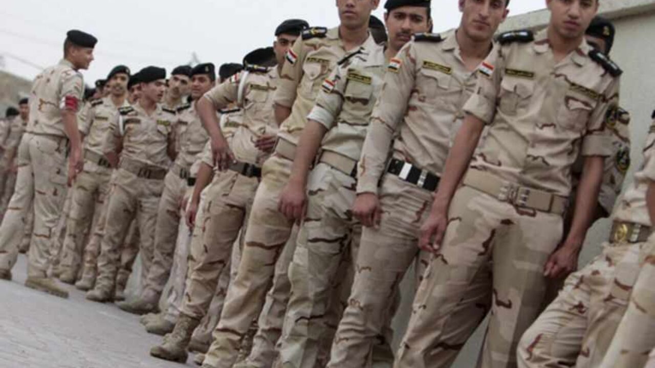 Iraqi security forces wait in line to vote, outside a polling station in Basra, 420 km (261 miles) southeast of Baghdad April 13, 2013. Members of the Iraqi security forces head to polling stations on Saturday in Baghdad and other Iraqi provinces to cast their ballot in the 2013 provincial council election. REUTERS/Atef Hassan  (IRAQ - Tags: ELECTIONS POLITICS MILITARY) - RTXYK1F