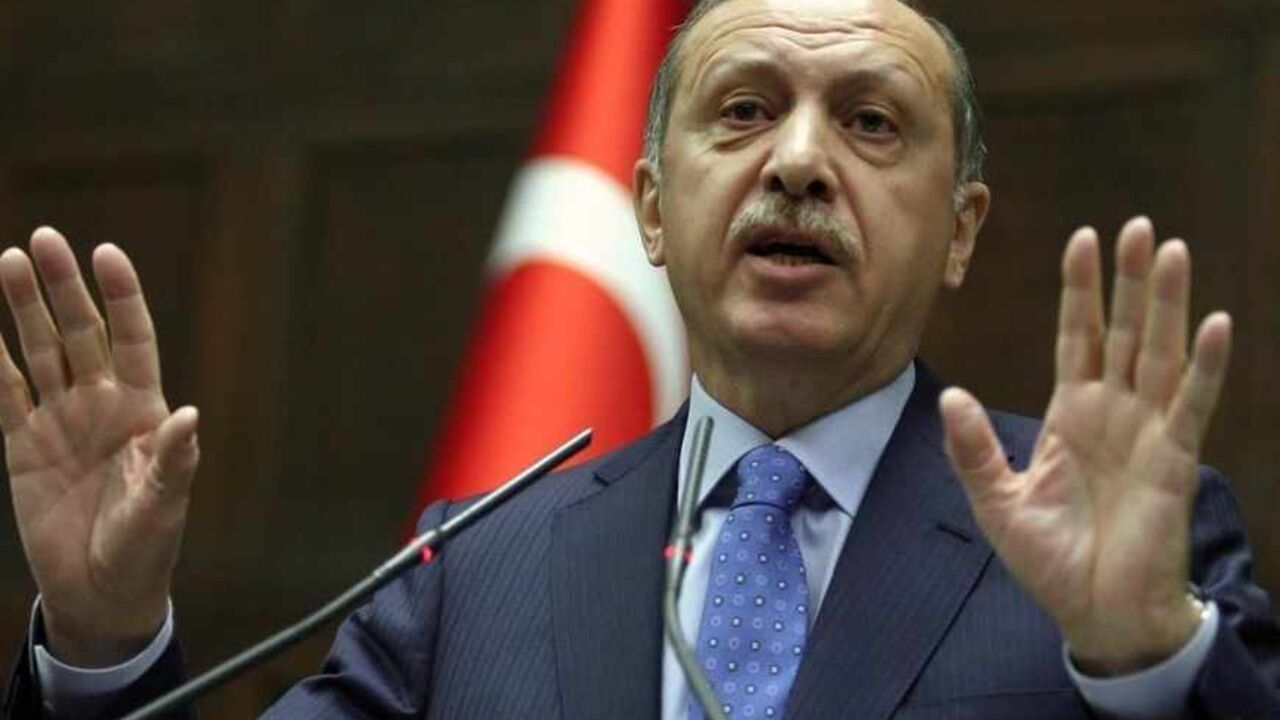 Turkey's Prime Minister Recep Tayyip Erdogan addresses his lawmakers in Ankara, on March 26, 2013. Erdogan said today that he planned to create a committee of "wise men" with an advisory role, to supervise the peace process currently underway with Kurdish rebels of the Kurdistan Workers Party (PKK). AFP PHOTO / ADEM ALTAN        (Photo credit should read ADEM ALTAN/AFP/Getty Images)