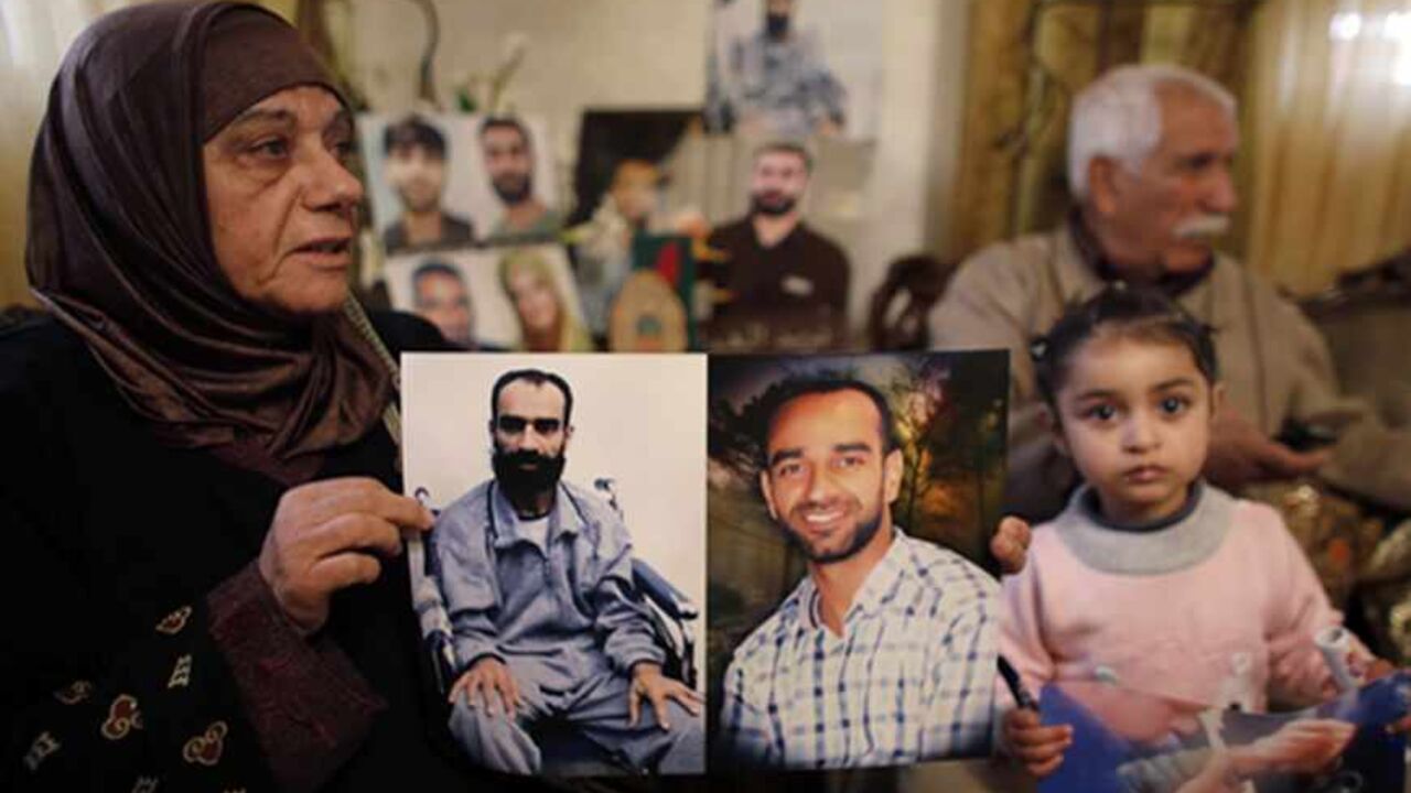 Layla al-Issawi holds a picture of her son Samer, who has been on hunger strike for 209 days while being held in an Israeli prison, at her home in the East Jerusalem neighbourhood of Issawiya February 17, 2013. The European Union on Saturday called on Israel to improve conditions for Palestinians in its jails, and a Palestinian minister said there would be rallies next week to support hunger-striking prisoners. Nearly 5,000 Palestinians are held in Israeli jails, many charged with involvement in attacks on 