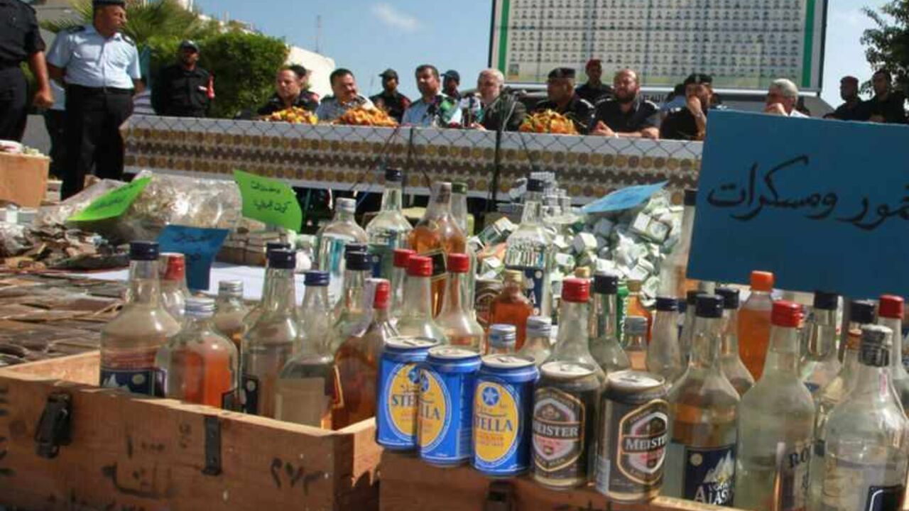 Member of Hamas' security forces hold a news conference as alcohol, seized by forces last month, is displayed to the media in Gaza City August 10, 2010. REUTERS/Suhaib Salem (GAZA - Tags: POLITICS CRIME LAW SOCIETY) - RTR2H7BM