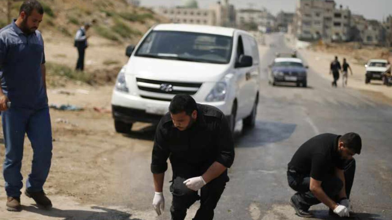 Palestinian policemen loyal to Hamas inspect the scene after an Israeli airstrike in Gaza City April 30, 2013. An Israeli airstrike killed a Palestinian and wounded another in the Gaza Strip on Tuesday, medics said, in the first targeted attack against militants since a ceasefire ended an eight-day war in November. REUTERS/Suhaib Salem (GAZA - Tags: CIVIL UNREST POLITICS) - RTXZ4BM