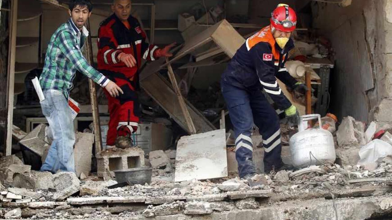 Search and rescue officers work at a damaged building at the site of blast in the town of Reyhanli in Hatay province, near the Turkish-Syrian border, May 13, 2013. Syria's information minister has blamed Turkey's government for deadly car bombings near the Syrian border and branded Prime Minister Tayyip Erdogan a "murderer", state-run Russian TV company RT reported on Monday. It said he repeated a denial of Syrian involvement in car bombings that killed 46 people on Saturday in the Turkish border town of Re