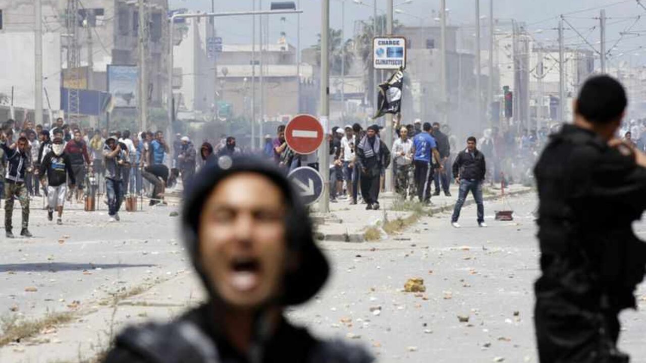 Supporters of Islamist group Ansar al-Sharia clash with riot police at Hai al Tadamon in Tunis May 19, 2013. Supporters of the hardline Islamist group clashed with Tunisian police in two cities on Sunday after the government banned its annual rally and the regional arm of al Qaeda urged it to stand firm against the authorities.  REUTERS/Anis Mili  (TUNISIA - Tags: CIVIL UNREST POLITICS RELIGION) - RTXZSQP