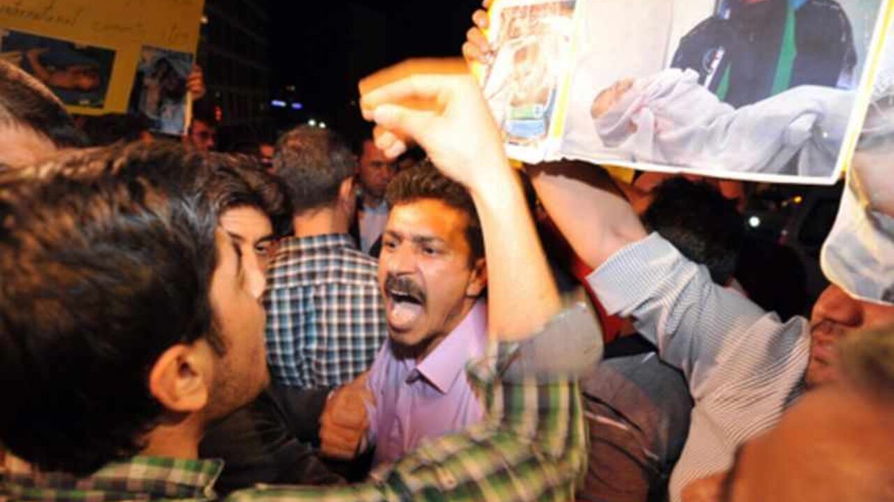 Syrian opposition activists argue outside the venue of the main opposition National Coalition meeting in Istanbul on May 26, 2013. Angry at the Coalition's failure to reach any agreement, a group of some 15 protesters gathered outside the hotel where the group was meeting, with some demanding speedier action and others rejecting negotiations outright."We want them to decide. They've been in there four days, discussing expansion while they should be taking a stand against Iran and Hezbollah's attack on Qusay