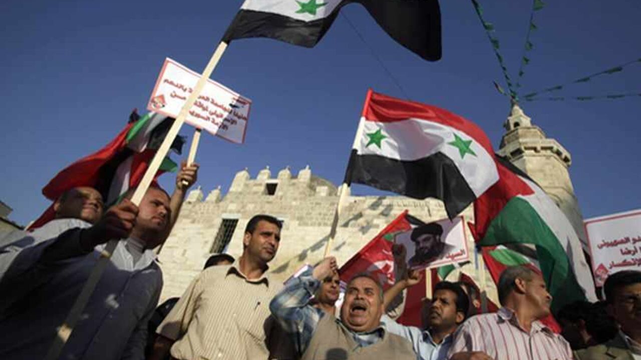 Palestinian supporters of leftist parties take part in a protest against Israeli air strikes close to Damascus, in Khan Younis in the southern Gaza Strip May 7, 2013. Israel played down weekend air strikes close to Damascus reported to have killed dozens of Syrian soldiers, saying they were not aimed at influencing its neighbour's civil war but only at stopping Iranian missiles reaching Lebanese Hezbollah militants. REUTERS/Ibraheem Abu Mustafa (GAZA - Tags: POLITICS CIVIL UNREST) - RTXZDWI