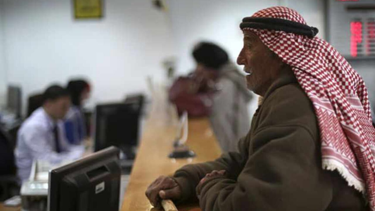 A Palestinian man waits at a counter to make a withdrawal at the Housing Bank for Trade & Finance in the West Bank city of Ramallah January 22, 2013. A central bank in the making, the Palestine Monetary Authority (PMA) is a rare bright spot as the economy of the Palestinian territories struggles with Israeli sanctions. Enforcing on Palestinian banks a regimen of conservative lending that has kept bad loans minimal and guaranteed liquidity, the PMA's technocratic prowess is the pinnacle of a Palestinian driv