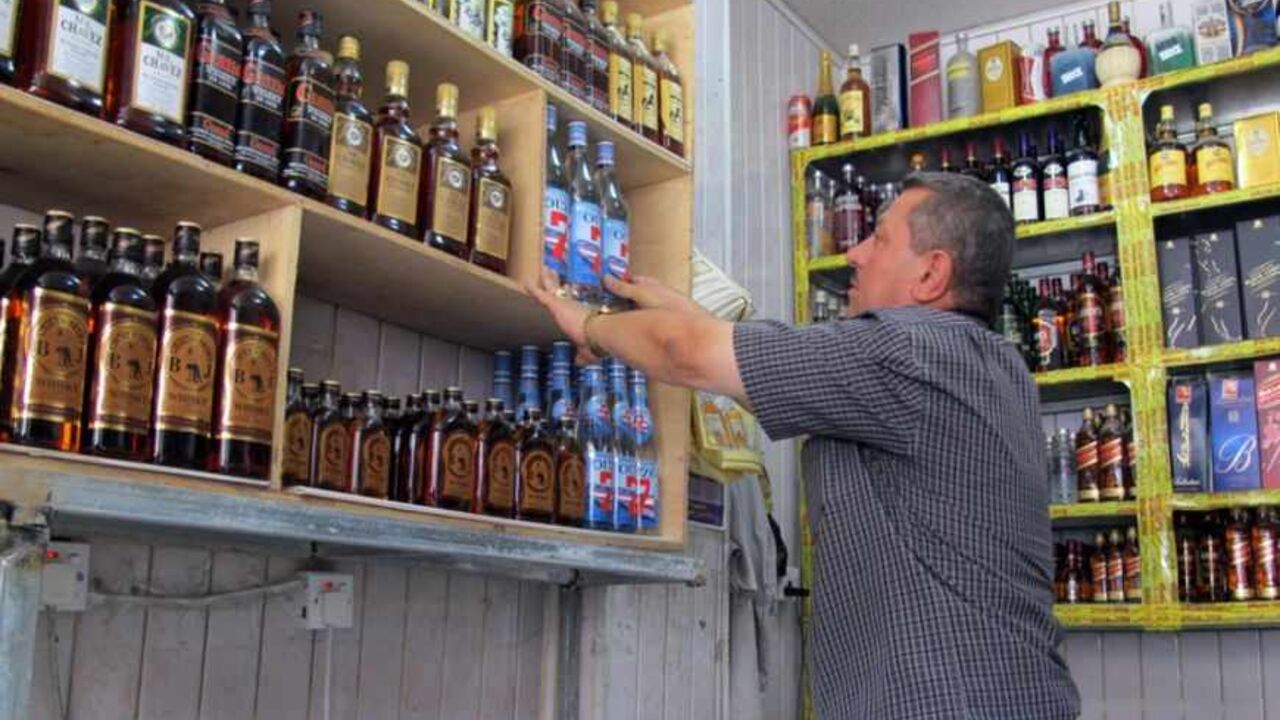 A shopkeeper arranges bottles in a shop in the Zayouna area of the Iraqi capital Baghdad, on May 15, 2013, the day after gunmen armed with silenced weapons shot dead 12 people at a row of alcohol shops in the Zayouna area of the capital.  AFP PHOTO/ KHALIL AL-MURSHIDI        (Photo credit should read KHALIL AL-MURSHIDI/AFP/Getty Images)