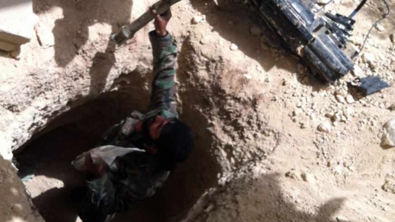 A picture taken on June 8, 2013 shows Syrian army soldiers gathering ammunition from a tunnel in the village of Buweida, north of Qusayr, in Syria's central Homs province. Forces loyal to President Bashar al-Assad have now seized all of the Qusayr area in central Syria, state television reported, as troops overran the last rebel bastion in the area. AFP PHOTO / STR        (Photo credit should read -/AFP/Getty Images)