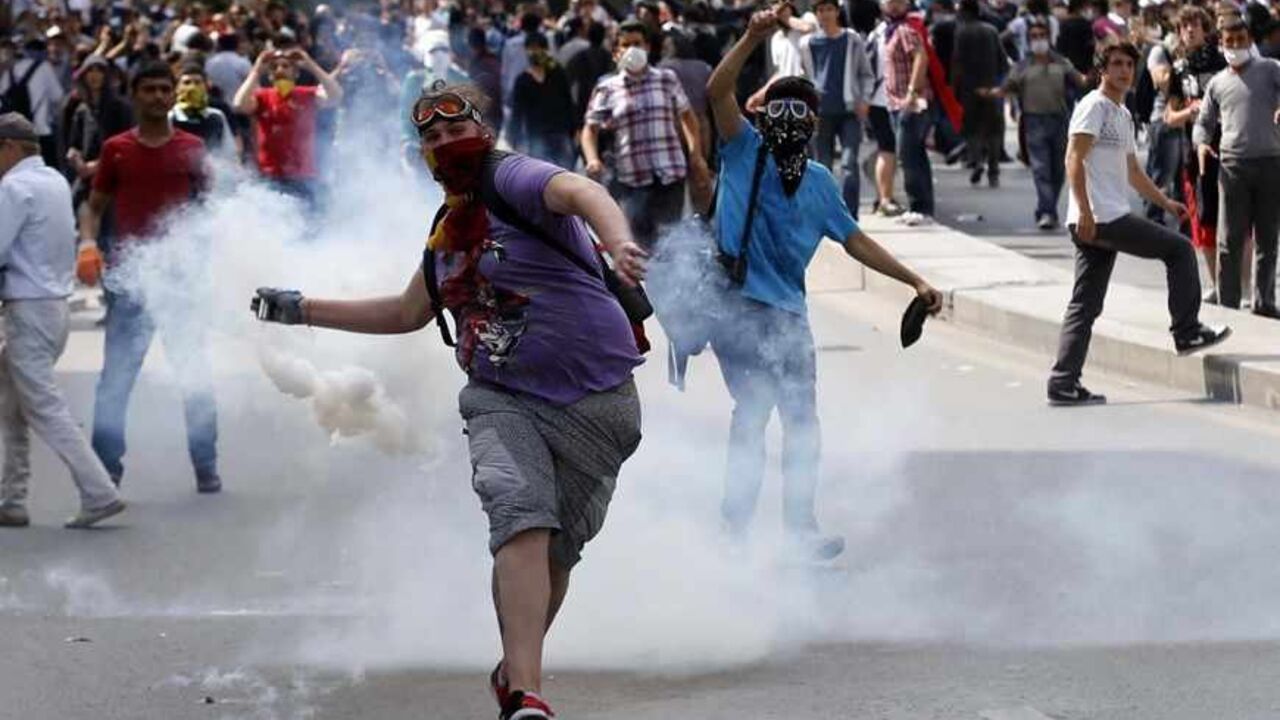 A protester throws a gas canister back at the riot police during a demonstration in Ankara, June 3, 2013. Turkish Prime Minister Tayyip Erdogan accused anti-government protesters on Monday of walking "arm-in-arm with terrorism", remarks that could further inflame public anger after three days of some of the most violent riots in decades. Hundreds of police and protesters have been injured since Friday in the riots, which began with a demonstration to halt construction in a park in an Istanbul square and gre