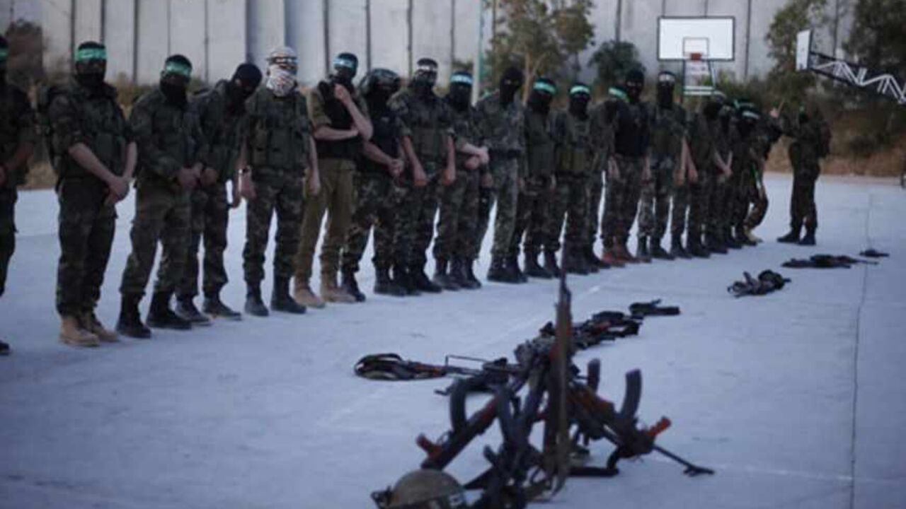 Hamas militants stand for prayer before a protest in the northern Gaza Strip April 2, 2013. Israeli prison guards fired tear gas to quell disturbances by Palestinian inmates on Tuesday after a prisoner serving a life sentence over an attempt to bomb an Israeli cafe died of cancer. Maysara Abu Hamdeya's death threatened to raise tensions in the Israeli-occupied West Bank, where Palestinians, who view jailed brethren as heroes in a fight for statehood, have held several protests in recent weeks in support of 
