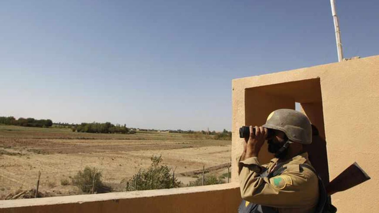 An Iraqi border policeman looks through a pair of binoculars near the Iraqi-Syrian borders at the Abu Kamal-qaim border crossing, the main border post between Iraq and Syria, September 8, 2012. Al Qaim, in the Sunni heartland of Anbar province, reflects the tricky balancing act Iraq's Shi'ite leaders face in Syria, whose crisis is testing the Middle East's sectarian divide. Al Qaim and its neighbouring Syrian counterpart Albu Kamal are on a strategic supply route for smugglers, gun-runners and now insurgent