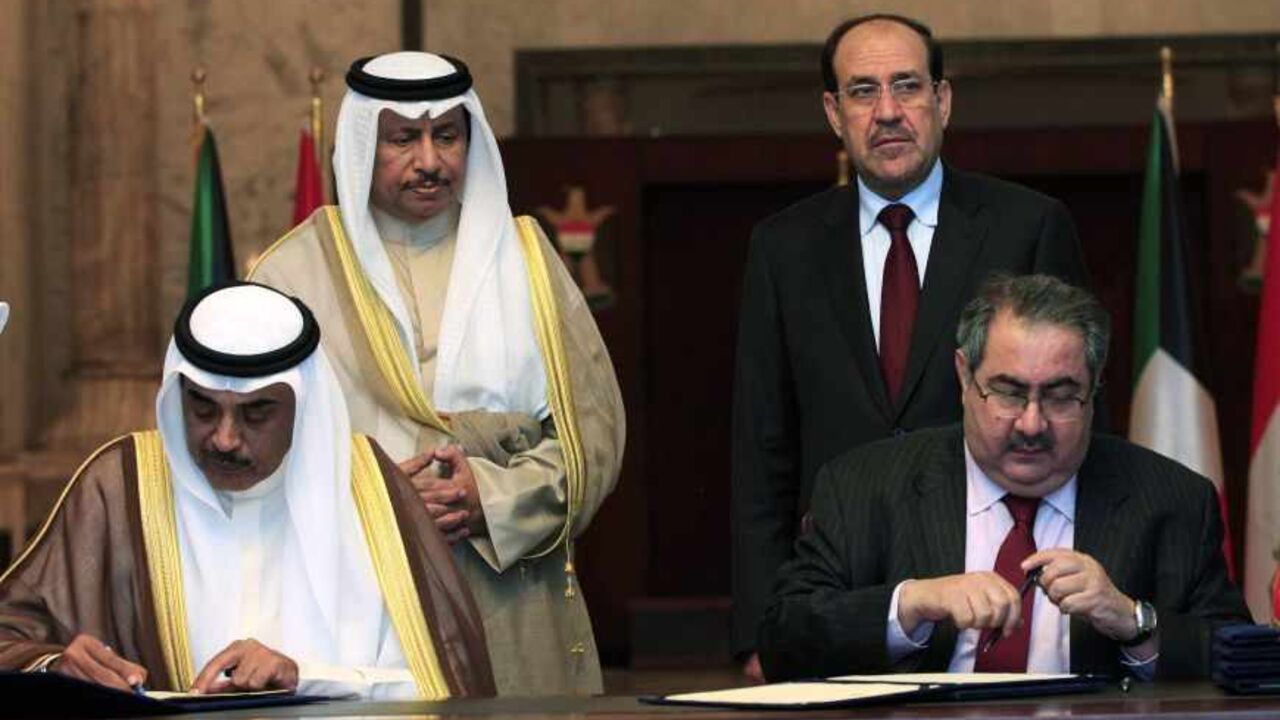 Kuwait's Prime Minister Sheikh Jaber Al-Mubarak Al-Hamad Al-Sabah (back L) and his Iraqi counterpart Nuri al-Maliki (back R) look on as Kuwait's Foreign Minister Sheik Sabah Khalid Al-Hamad Al-Sabah (front L) and his Iraqi counterpart Hoshyar Zebari sign agreements in Baghdad, June 12, 2013.  REUTERS/Karim Kadim/Pool  (IRAQ - Tags: POLITICS) - RTX10L6W