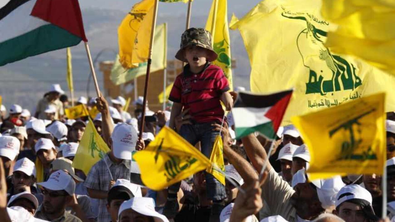 Supporters of Lebanon's Hezbollah wave Hezbollah and Palestinian flags during a rally to mark "Quds (Jerusalem) Day" in the southern Lebanese village of Maroun el-Ras, near the border with Israel, August 26, 2011. Lebanon's Hezbollah chief Sayyed Hassan Nasrallah, whose group is backed by Damascus, warned that the unrest in Syria will have implications on the whole region if it is not solved through dialogue. "We all support the need for big and important reforms, so Syria can be stronger...this means that 