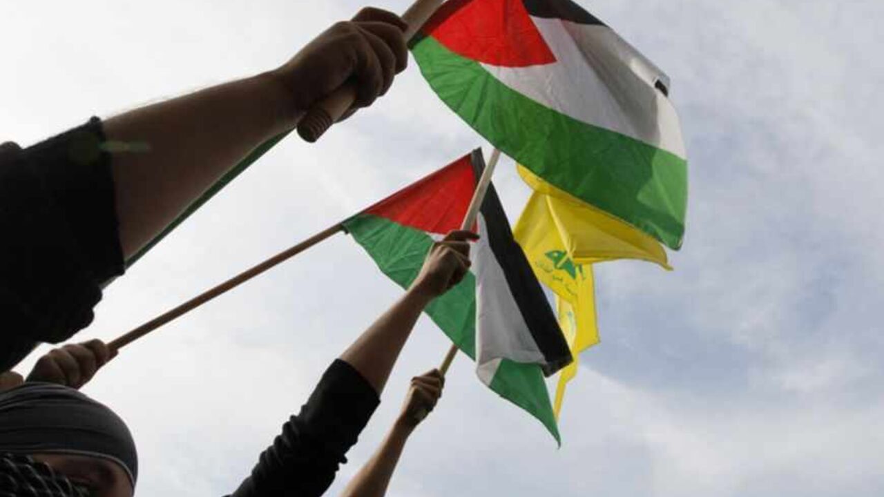 Lebanon's Hezbollah supporters wave Palestinian and Hezbollah flags during a demonstration, organised by Lebanese and Palestinian factions, against Israel's military operation in Gaza, in front of the U.N. headquarters in Beirut November 17, 2012. Israeli aircraft bombed Hamas government buildings in Gaza on Saturday, including the prime minister's office, after Israel's cabinet authorised the mobilisation of up to 75,000 reservists, preparing for a possible ground invasion. REUTERS/Jamal Saidi (LEBANON - T