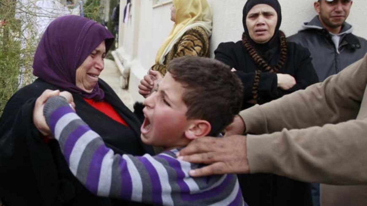 A Palestinian boy cries during the demolition of his house in the East Jerusalem neighbourhood of Beit Hanina February 5, 2013. A statement from the Jerusalem Municipality said there was a court order for the demolition of the house, which was built without a permit in an open landscape area where construction is forbidden. REUTERS/Ammar Awad (JERUSALEM - Tags: POLITICS CIVIL UNREST BUSINESS CONSTRUCTION) - RTR3DDR4
