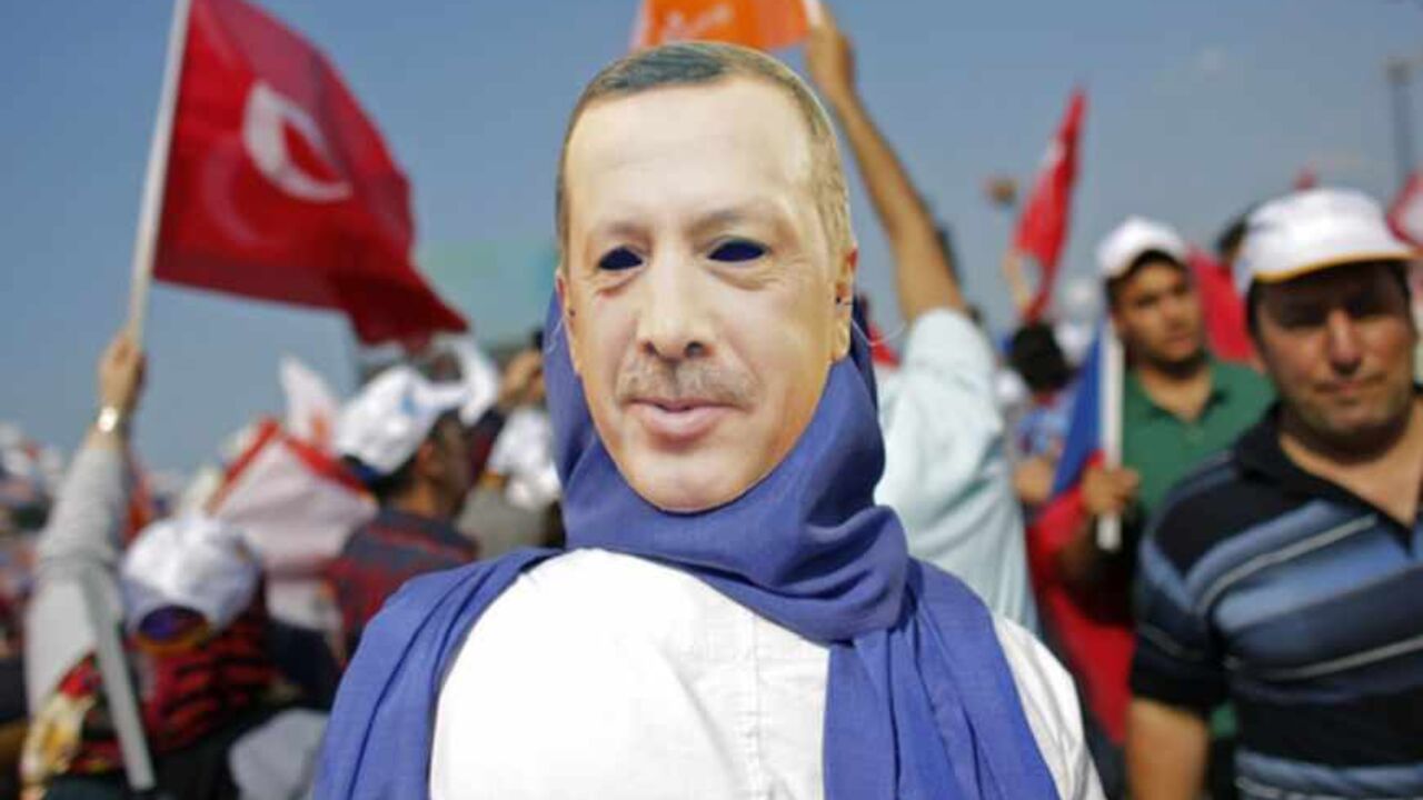 A supporter wears a mask showing Turkish Prime Minister Tayyip Erdogan during a rally of ruling AK party in Istanbul June 16, 2013. Tens of thousands of Erdogan's supporters massed at a rally in Istanbul on Sunday, as riot police fired tear gas to break up pockets of anti-government protesters in the city center several kilometers away. REUTERS/Murad Sezer (TURKEY  - Tags: POLITICS CIVIL UNREST)   - RTX10PV2
