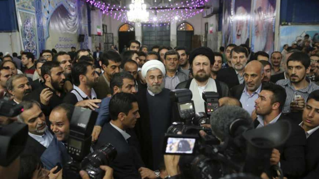 Iranian President-elect Hassan Rohani (C) speaks to the media following a visit to the Khomeini mausoleum in Tehran June 16, 2013. Reuters/Fars News/Seyed Hassan Mousavi   (IRAN - Tags: POLITICS) ATTENTION EDITORS - THIS IMAGE WAS PROVIDED BY A THIRD PARTY. FOR EDITORIAL USE ONLY. NOT FOR SALE FOR MARKETING OR ADVERTISING CAMPAIGNS. THIS PICTURE IS DISTRIBUTED EXACTLY AS RECEIVED BY REUTERS, AS A SERVICE TO CLIENTS - RTX10Q47