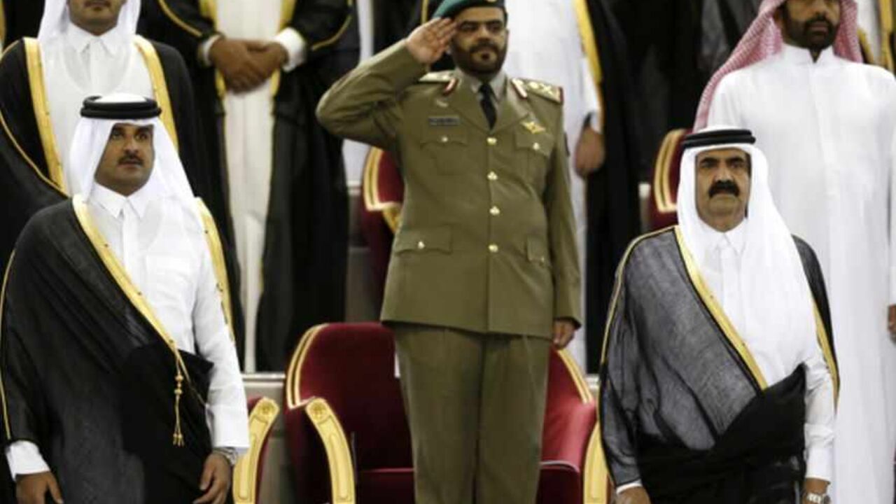 Qatar's Emir Sheikh Hamad bin Khalifa al-Thani (R) stands next to his son Crown Prince Sheikh Tamim bin Hamad al-Thani before the Emir Cup final match between Al-Sadd and Al-Rayyan at Khalifa stadium in Doha May 18, 2013. REUTERS/Fadi Al-Assaad (QATAR - Tags: SPORT SOCCER ROYALS POLITICS) - RTXZRXO