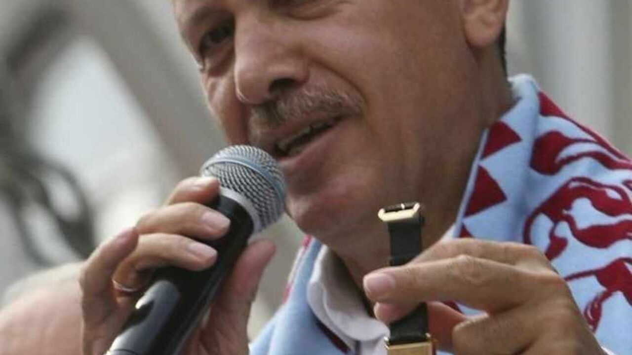 Turkish Prime Minister Tayyip Erdogan displays a watch with a signature of former Prime Minister Adnan Menderes engraved on it, during a rally of his ruling AK Party to campaign for Sunday's early parliamentary elections in Turkey's Black Sea city of Trabzon July 20, 2007. The watch was presented to him by a supporter.  REUTERS/Fatih Saribas  (TURKEY) - RTR1S2C8