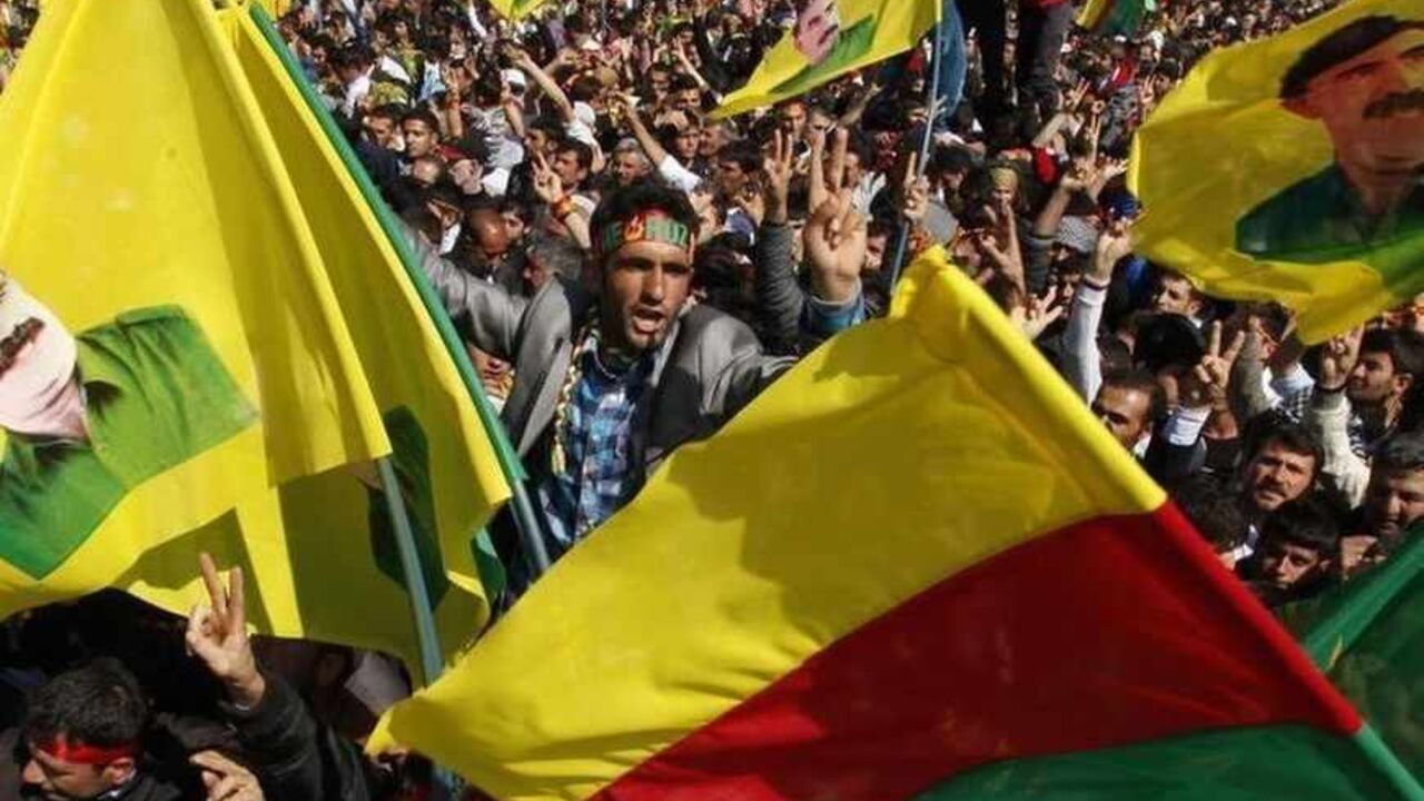 Demonstrators hold Kurdish flags and portraits of jailed Kurdistan Workers Party (PKK) leader Abdullah Ocalan during a gathering to celebrate Newroz in the southeastern Turkish city of Diyarbakir March 21, 2013. Jailed Kurdish rebel leader Abdullah Ocalan ordered his fighters on Thursday to cease fire and withdraw from Turkish soil as a step to ending a conflict that has killed 40,000 people, riven the country and battered its economy. Hundreds of thousands of Kurds gathered in the regional centre of Diyarb