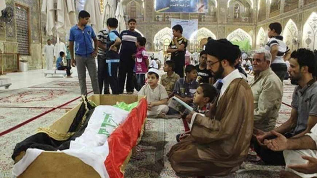 Mourners pray at the coffin of a victim killed during an attack on a prison in Taji, during a funeral at the Imam Ali shrine in Najaf, 160 km (100 miles) south of Baghdad July 22, 2013. Sixteen soldiers and six militants were killed during an attack on the prison on Sunday in Taji, around 20 km (12 miles) north of Baghdad, but guards managed to prevent any inmates escaping. The attack was conducted simultaneously and followed a similar pattern as the attack on Abu Ghraib jail, where hundreds of convicts, in